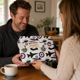 A man is smiling as he presents a gift to a woman, which appears to be a personalized item with a military theme.
