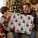 A young boy is handing a wrapped gift to an older man, both smiling and appearing happy.