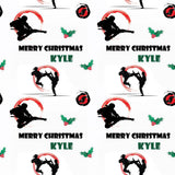 a repeating pattern of silhouetted figures performing martial arts moves, along with holly leaves and the text "Merry Christmas Kyle" written in various styles and colors.