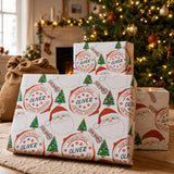 a set of Christmas-themed gift boxes with Santa Claus and Christmas trees in the background, creating a festive atmosphere.