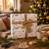 A festive Christmas scene with a wrapped gift, a mug, a pair of scissors, and a cozy blanket on a wooden table.
