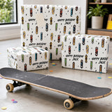 A skateboard is placed on the floor in front of three gift boxes with a skateboard design, and there are scattered confetti around the skateboard.