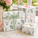 three gift boxes with polka dot patterns and a green ribbon bow, placed on a wooden surface. There are also pink confetti scattered around the boxes.