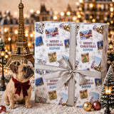 A small dog wearing a red bow tie sits next to a large gift box with a bow, surrounded by Christmas decorations and lights.