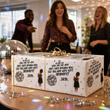a gift box with a disco ball design, and there are two women standing behind it, smiling and laughing.