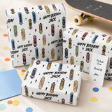 a set of birthday gift boxes with a skateboard theme, along with a skateboard and some confetti on the floor.