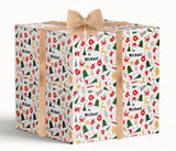 A large, white gift box with a burlap bow tied around it. The gift box has a pattern of Christmas trees, ornaments, and other festive elements on its surface. The text "To Michael" is visible on the gift box, indicating it is a gift for someone named Michael.