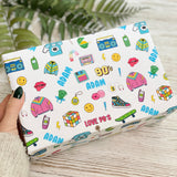 A hand holding a white gift box with a repeating pattern of colorful icons and text, including a telephone, radio, and various 90s-style clothing and accessories.