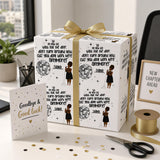 a gift box with a gold ribbon, decorated with a dancing woman and a disco ball, placed on a desk with a card, scissors, and other office supplies.