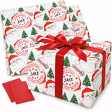 a pair of Christmas-themed gift boxes with Santa Claus and Christmas trees printed on them. The boxes are wrapped in red ribbon and have the name "Jake" printed on them.