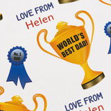 a collage of various objects, including a trophy, ribbons, and text. The trophy is prominently displayed in the center, with the text "WORLD'S BEST DAD!" written on it. The ribbons surrounding the trophy appear to be awards or ribbons, and the text "LOVE FROM Helen" is visible in the image.