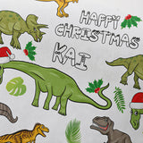 a collage of cartoon dinosaur illustrations, including a green dinosaur wearing a Santa hat, surrounded by holiday-themed elements such as holly leaves and a "Happy Christmas" message.