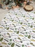 a white surface with a repeating pattern of Christmas-themed illustrations, including a Christmas tree, pine cones, and fishing gear. The pattern is designed to be personalized with the name "Jamel" written on it.
