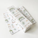 a white background with a repeating pattern of a white box with illustrations of a wedding cake, flowers, and a car. The text "Mr & Mrs Mullins" is printed on the boxes, and there is a date "23.4.2023" printed below the illustrations.