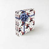 A gift box with a Spiderman theme, featuring the character in various poses and surrounded by a pattern of red and white colors.