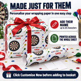 The image is an advertisement for a personalized wrapping paper product called "Happy Birthday Simon". It features a large gift box with a red ribbon and a dartboard pattern, along with a dartboard-themed wrapping paper roll. The text on the product suggests that it can be used to personalize wrapping paper and add a name to it.