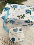 A white gift box with a blue floral pattern and a ribbon, along with a small card that reads "60th Wedding Anniversary Mum & Dad" and "Dover Wedding Anniversary".
