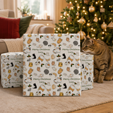 A cat is sitting on the floor in front of a Christmas tree, with wrapped presents in the background.