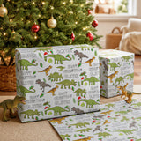 two dinosaur-themed gift boxes with the name "OLIVER" printed on them, placed in front of a Christmas tree decorated with ornaments.