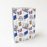 The image is a square-shaped gift box with a repeating pattern of Christmas-themed images, including snowflakes, trees, and buildings.
