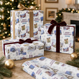 three Christmas gift boxes with festive designs, placed on a table with ornaments and a lit fireplace in the background.