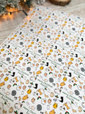 a close-up view of a white paper with a repeating pattern of cats and Christmas-themed elements, such as leaves and snowflakes. The paper has a festive and holiday-inspired design, with the text "Merry Christmas Priscilla" visible on it.