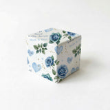 A white gift box with a floral pattern and the words "Wedding Anniversary" printed on it.