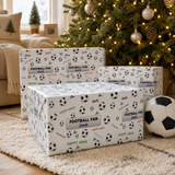 three wrapped football fan gifts with the names "Jack" and "Cameron" printed on them, placed on a rug in front of a Christmas tree with lights.