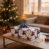 A Spiderman-themed gift box with a blue bow sits on a coffee table in front of a lit Christmas tree.