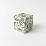 A white gift box with a repeating pattern of green dinosaurs on a white background.
